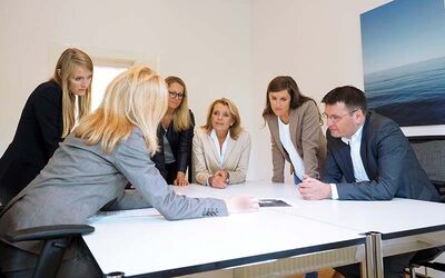People talking and sitting around a table 